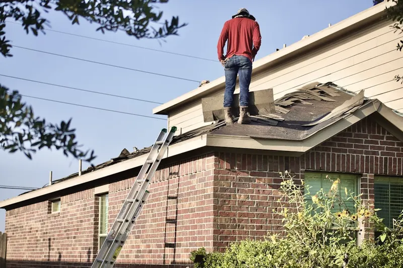 Professional roofer working on a residential roof in Allgates